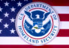 U.S. Department of Homeland Security emblem on a background of the American flag