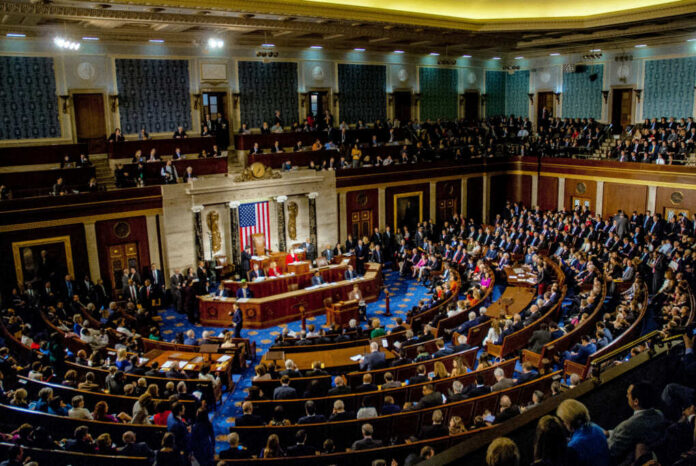 shutterstock_1186368262-4 A large gathering of officials in a congressional chamber during a legislative session