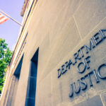 Seven-Year-Old’s Death Sparks Murder Push Exterior view of the Department of Justice building with an American flag