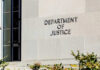 Judge Reopens Trump-vs-DOJ Deal Sign on the exterior wall of the Department of Justice building