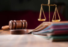 Supreme Curveball Scrambles State Abortion Bans A wooden gavel and scales of justice on a table with law books