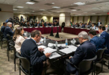 Inflation Sting: Fed Ditches Cut Hopes A formal government meeting with officials seated around a table and media present