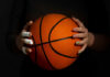 LSU Outrage Triggers Sudden LA Times Flip Hands with bandages holding an orange basketball against a dark background