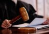 Boston Judge Freezes Paxton’s ActBlue Push A judges gavel poised above a wooden block with a document in the background