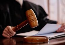 Boston Judge Freezes Paxton’s ActBlue Push A judges gavel poised above a wooden block with a document in the background