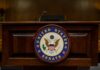 Surveillance Showdown Erupts in Senate Podium with the United States Senate seal in a formal setting