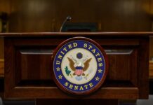 Surveillance Showdown Erupts in Senate Podium with the United States Senate seal in a formal setting