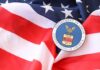 Blue-State Blowback Meets DOJ Heat U.S. Department of Labor seal on an American flag