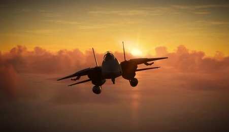 shutterstock_2483635841 Military aircraft flying against a sunset backdrop