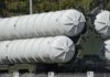 Close-up of a military missile system with cylindrical launchers