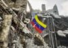 U.S. Rushes In, Caracas Left Waiting Venezuelan flag among ruins of a collapsed concrete building