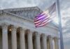 Birthright Showdown Shakes Washington The Supreme Court building with an American flag waving in front