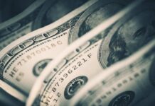 Phantom Contractors Exposed — $6B Frozen Close-up of folded hundred dollar bills
