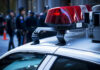 Mystery Boom Triggers Massive I‑290 Lockdown Close-up of a police car with red lights and officers in the background