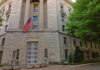 Sex Offender Returns: Judge Drops 46 Months Exterior view of a government building featuring the American flag and decorative entrance