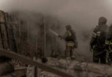 Drunk Driver Sparks Toxic Inferno Firefighters spray water into a smoke-filled structure