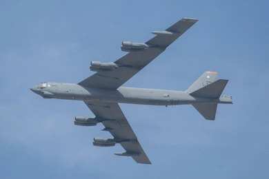2711985779 Military bomber aircraft flying against a blue sky