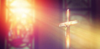 A crucifix illuminated by soft light in a church setting