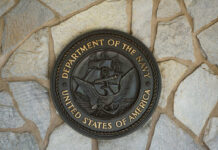 $100B Naval Fiasco Exposed Bronze seal of the Department of the Navy mounted on a stone wall