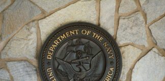 Bronze seal of the Department of the Navy mounted on a stone wall
