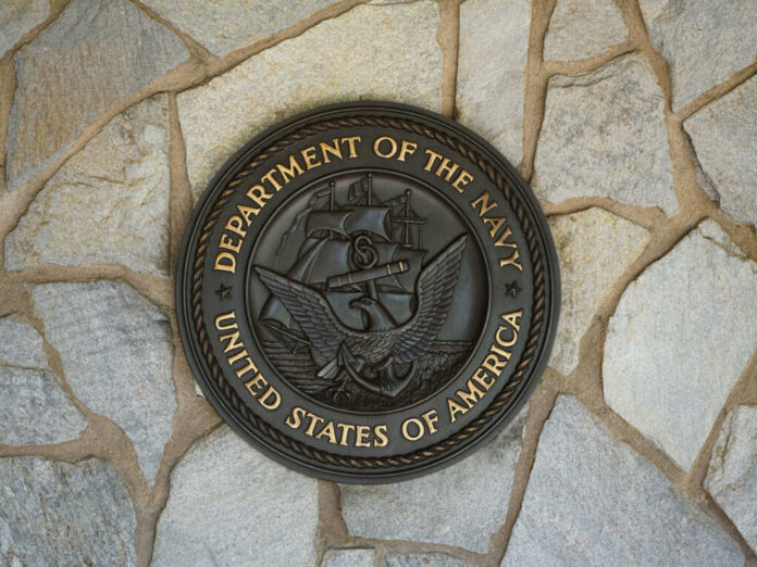 shutterstock2010674780jpg Bronze seal of the Department of the Navy mounted on a stone wall