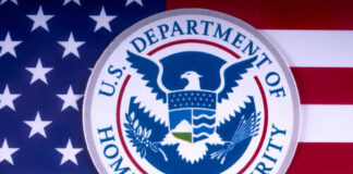U.S. Department of Homeland Security emblem on a background of the American flag