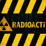 SHOCKING Move: Lithuania Scraps Nuke Ban Radioactive warning sign with yellow stripes and a caution symbol