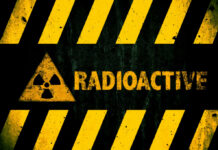SHOCKING Move: Lithuania Scraps Nuke Ban Radioactive warning sign with yellow stripes and a caution symbol