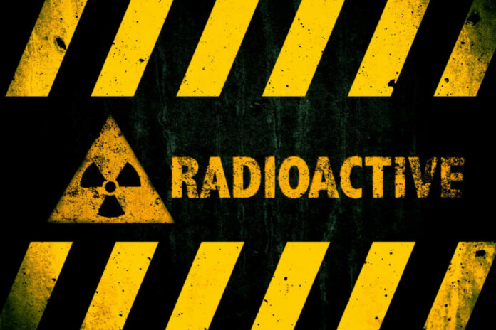 shutterstock_1133461070 Radioactive warning sign with yellow stripes and a caution symbol