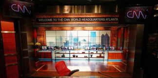CNN studio set with empty anchor desk and red chair