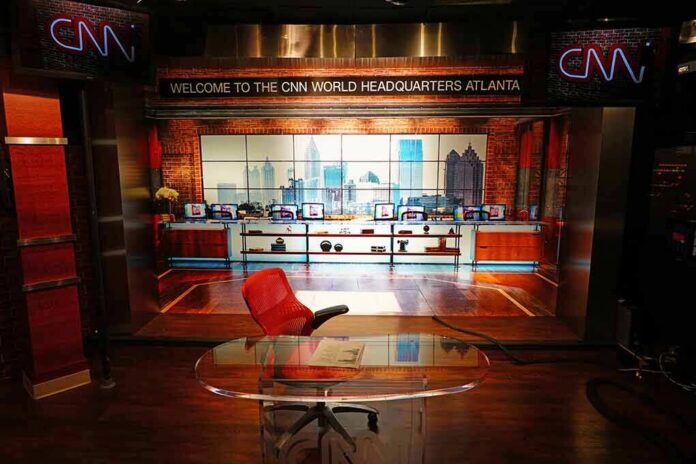 shutterstock_1284301786 CNN studio set with empty anchor desk and red chair