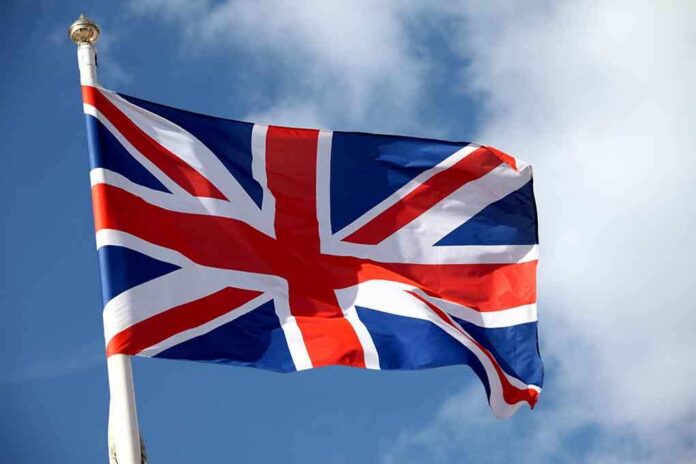 shutterstock_136536068 British flag waving against a blue sky