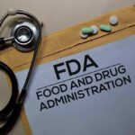 FDA Fast-Tracks Pain Pill—Who Cashes In? FDA document with stethoscope, pills, and pencil on envelope
