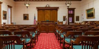 Courtroom with wooden benches facing the judge's bench