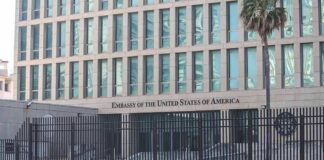 Embassy building behind tall black security fence