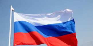 Russian flag waving against a clear blue sky