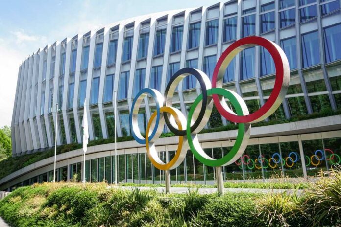 Headquarters,International,Olympic,Committee.,Olympic,Rings.,Lausanne,,Switzerland,-,June Colorful Olympic rings displayed in front of a modern building