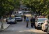 Shadow War Hits Home In Russia Police officers secure a residential street with patrol cars and yellow tape