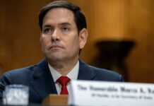 Godless Revolutions: Rubio’s Bombshell Claim A government official sitting at a hearing with a serious expression