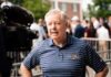 Sudden Collapse—Autopsy Silence Stokes Fury A man in a striped shirt speaking during a media interview at an outdoor event