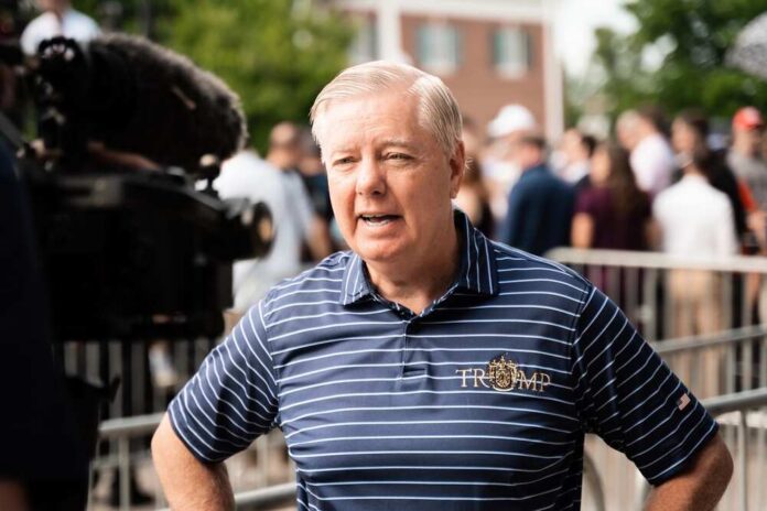 Pickens,,South,Carolina,,Usa,,July,1,,2023:,Senator,Lindsey A man in a striped shirt speaking during a media interview at an outdoor event