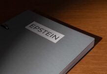 Judge Says DOJ Admitted Epstein Law Violation A metallic folder labeled 'EPSTEIN' resting on a wooden surface