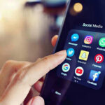 Facebook, TikTok Supercharged Child Lures Finger tapping smartphone social media app icons.