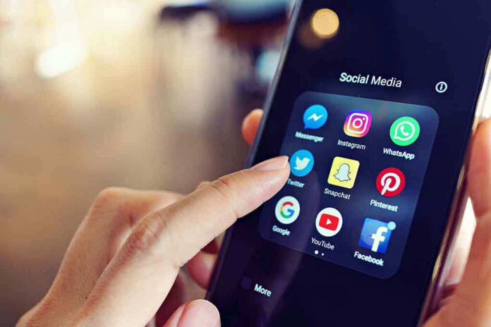 1064490605 Finger tapping smartphone social media app icons.