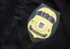 Sanctuary Standoff Sparks Risky Street Busts ICE officer badge on a dark uniform