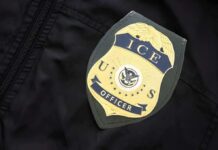 Sanctuary Standoff Sparks Risky Street Busts ICE officer badge on a dark uniform
