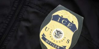 ICE officer badge on a dark uniform