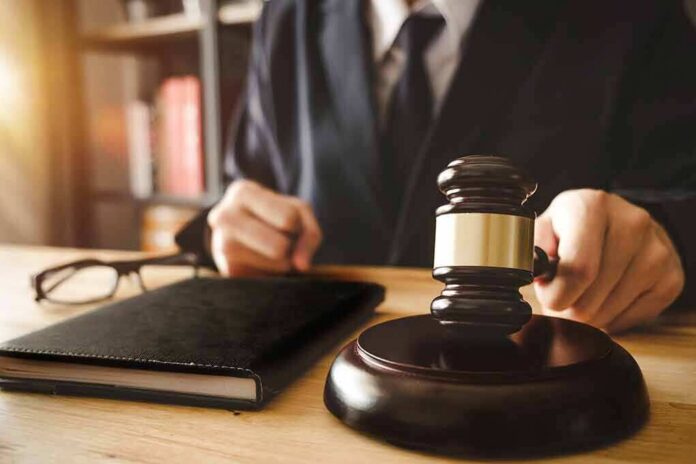shutterstock_1035925210 Judge with gavel striking sound block