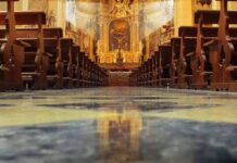 Bishop’s Letter Axes Longtime Latin Mass Church interior with wooden pews facing ornate altar