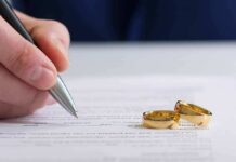 Caregiver Dating Bombshell Sparks Fury Hand signing a document beside two gold wedding rings